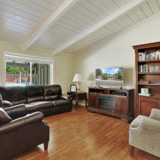 Cozy living room with leather sofas and a large bookshelf.
