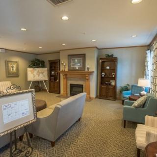 A cozy living room with a fireplace, comfortable seating, and tasteful decor.