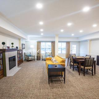 A spacious and modern living room featuring comfortable furniture and a cozy dining area.