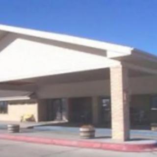 A photo of a building exterior with a prominent roof and pillar design.