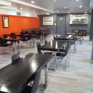 A modern restaurant interior with neatly arranged tables and chairs.