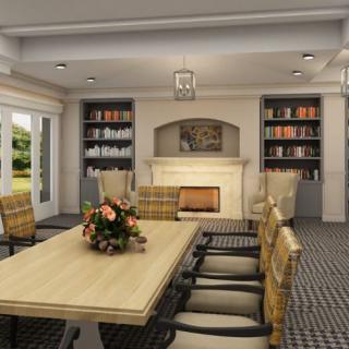 A cozy dining room with a large table, surrounded by chairs and adorned with a fireplace and bookshelves.