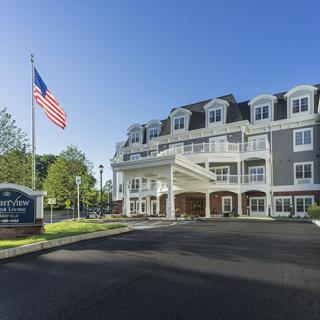A hotel with a grand entrance and an American flag flying outside.