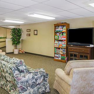 A cozy basement living room with comfortable seating and entertainment options.