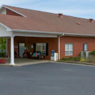 A welcoming residential building with a covered entrance and landscaped surroundings.