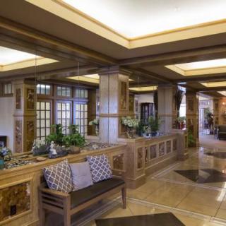A stylish lobby with modern architectural features, including a seating area and ceiling lights.