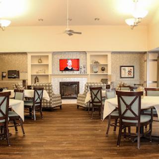 A cozy dining area with comfortable seating, a fireplace, and a television for communal enjoyment.