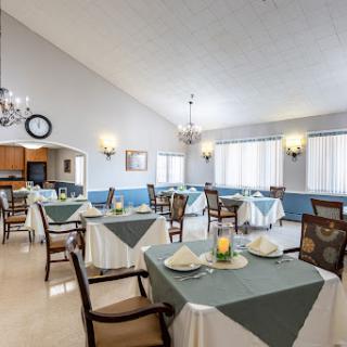 A spacious dining area featuring neatly arranged tables and chairs, suitable for casual dining.