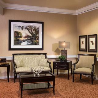 A cozy living room with elegant furniture and artwork.