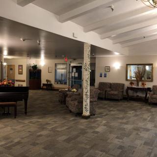 A cozy lobby area with ample seating and a piano.