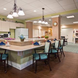 A modern kitchen and dining area with stylish lighting and seating.