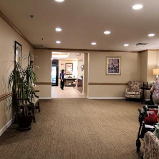 A spacious lobby area featuring comfortable seating, decorative plants, and warm lighting.