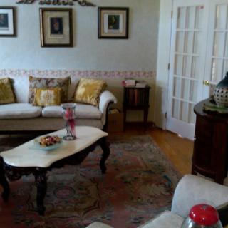 A cozy living room with elegant furnishings and decorative art pieces.
