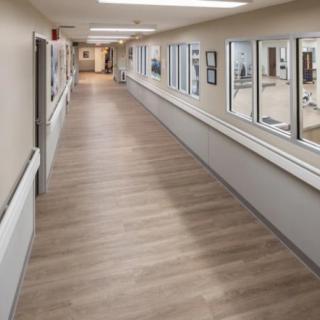 An empty hospital corridor with clean and well-lit surroundings.