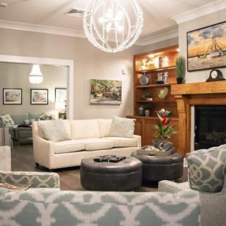 A modern living room with a cozy fireplace, elegant seating, and stylish decor.