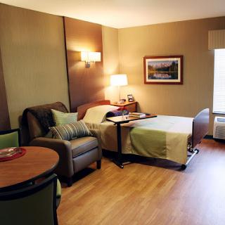 A cozy hotel room featuring modern furniture and warm lighting.