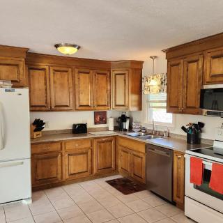 A cozy kitchen featuring wooden cabinets and modern appliances.