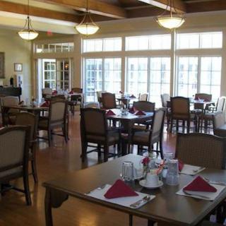A spacious and well-lit dining area with arranged tables and chairs.