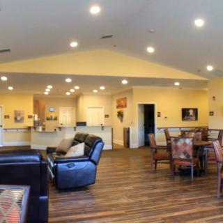 A spacious living area with comfortable seating and warm lighting.