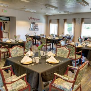 An elegantly set dining area with neatly arranged tables and chairs.