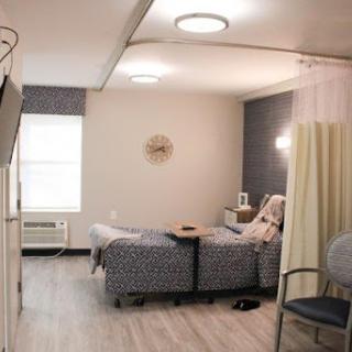 A well-lit and organized hospital patient room designed for comfort and care.