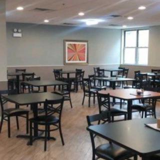 An empty dining area with tables and chairs arranged neatly.