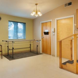A spacious rehabilitation room featuring therapy equipment and accessible design.