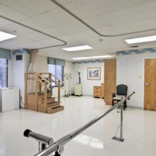 A rehabilitation room equipped with parallel bars for physical therapy exercises.