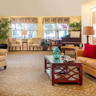 A cozy and well-decorated living room with sofas, a coffee table, and indoor plants.
