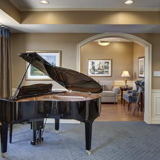 A beautifully designed living room featuring a grand piano.