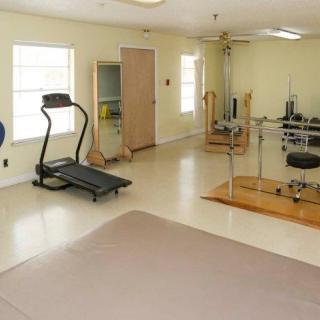 A home gym featuring a treadmill and various exercise equipment.