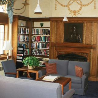 A cozy library reading area with bookshelves and comfortable seating.