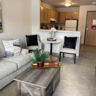 A stylish and modern living room area seamlessly connected to the kitchen.