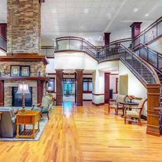A spacious and elegantly designed lobby featuring a grand staircase and cozy seating areas.