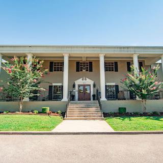 A beautiful two-story home featuring classic architectural elements and well-maintained landscaping.