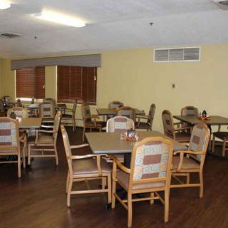 An empty dining room with arranged tables and chairs.