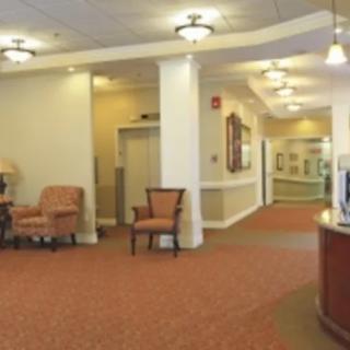 A spacious lobby area with comfortable seating and warm lighting.
