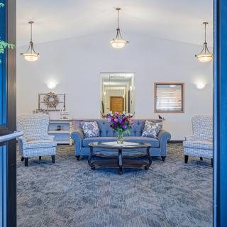 A well-decorated living room with comfortable seating and tasteful lighting.