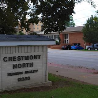 A view of the Crestmont North building with a visible sign and surrounding parking area.