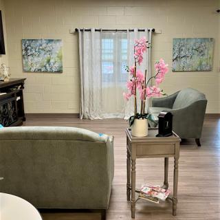 A cozy living room featuring comfortable seating and decorative elements.