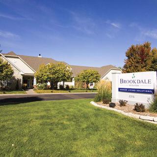 A well-maintained building with a landscaped lawn and prominent signage.