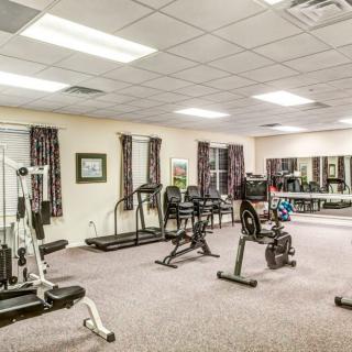 A fitness room equipped with various exercise machines and workout equipment.