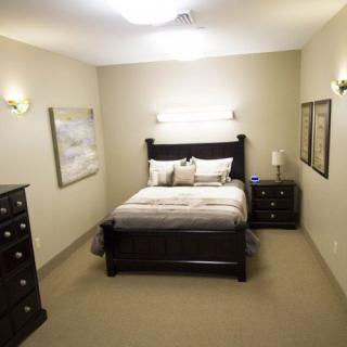 A modern bedroom with elegant furniture and soft lighting.