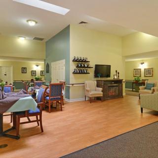 A spacious living and dining area with comfortable seating and a television.