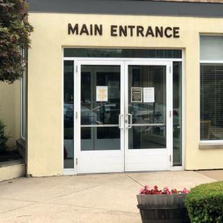 Main entrance of a building with glass doors.