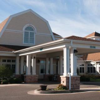 A residential building with a large entrance and covered driveway.