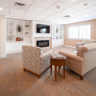 A cozy and modern living room featuring comfortable seating, a fireplace, and a television.