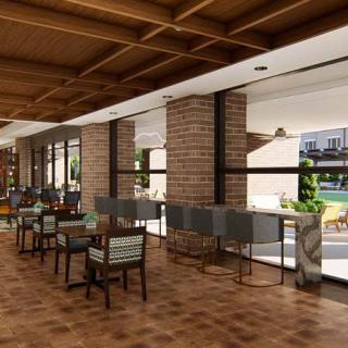 A modern cafe interior with brick walls, wooden ceilings, and ample natural light.