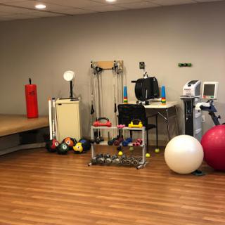 A well-equipped fitness and rehabilitation space featuring various exercise tools.