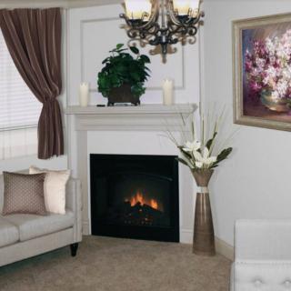 A cozy living room featuring a fireplace, elegant artwork, and tasteful decor.